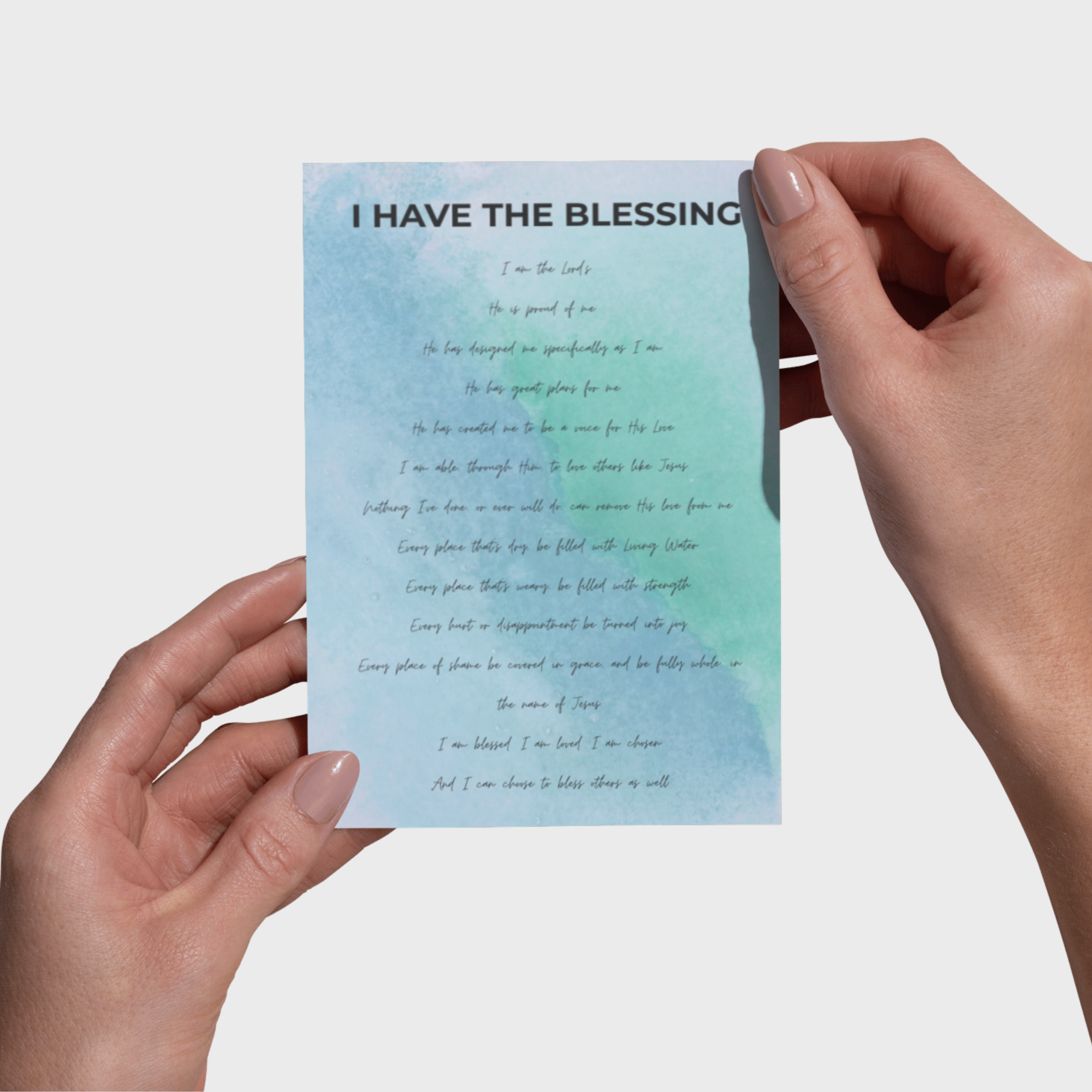 Hands holding a 5x7 print with text on a light blue background