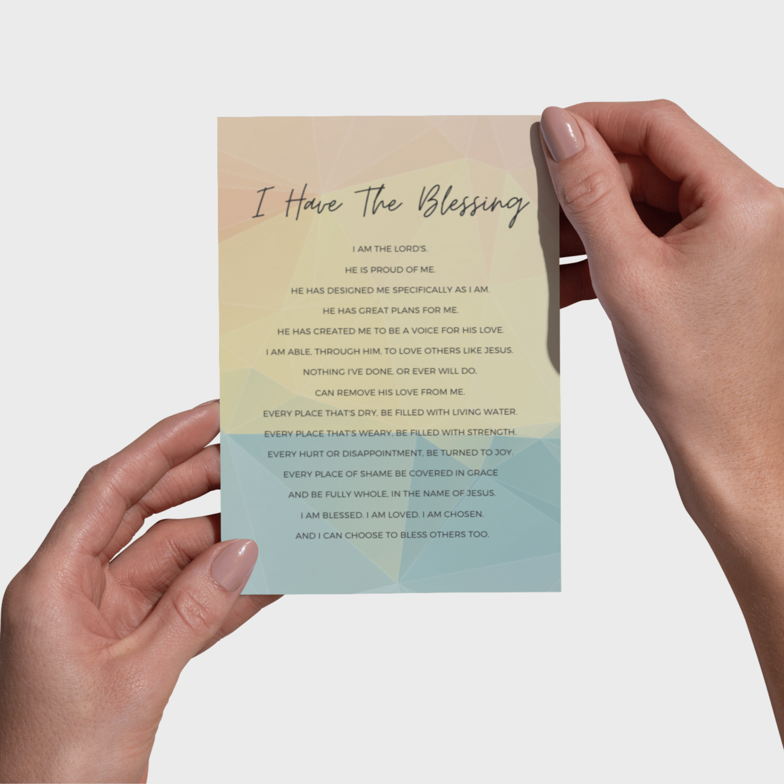 Hands holding a 5x7 print with text on a light background