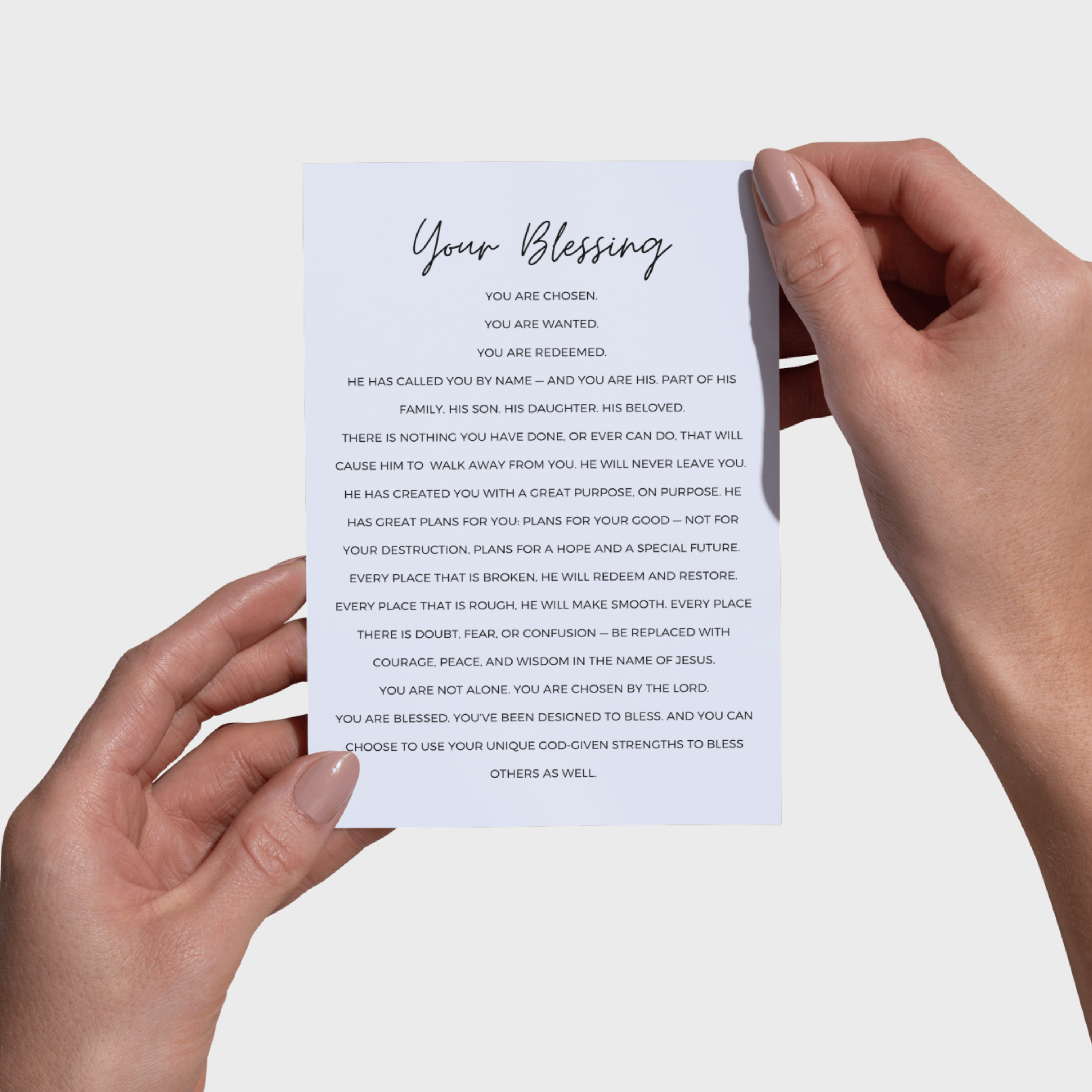 Hands holding a 5x7 printwith 'Your Blessing' text on a light background