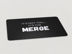 Magnet with "It's Not You...It's the Merge" written in white text on a black background