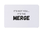A magnet with the text 'It's Not You, It's The Merge' on a white background.